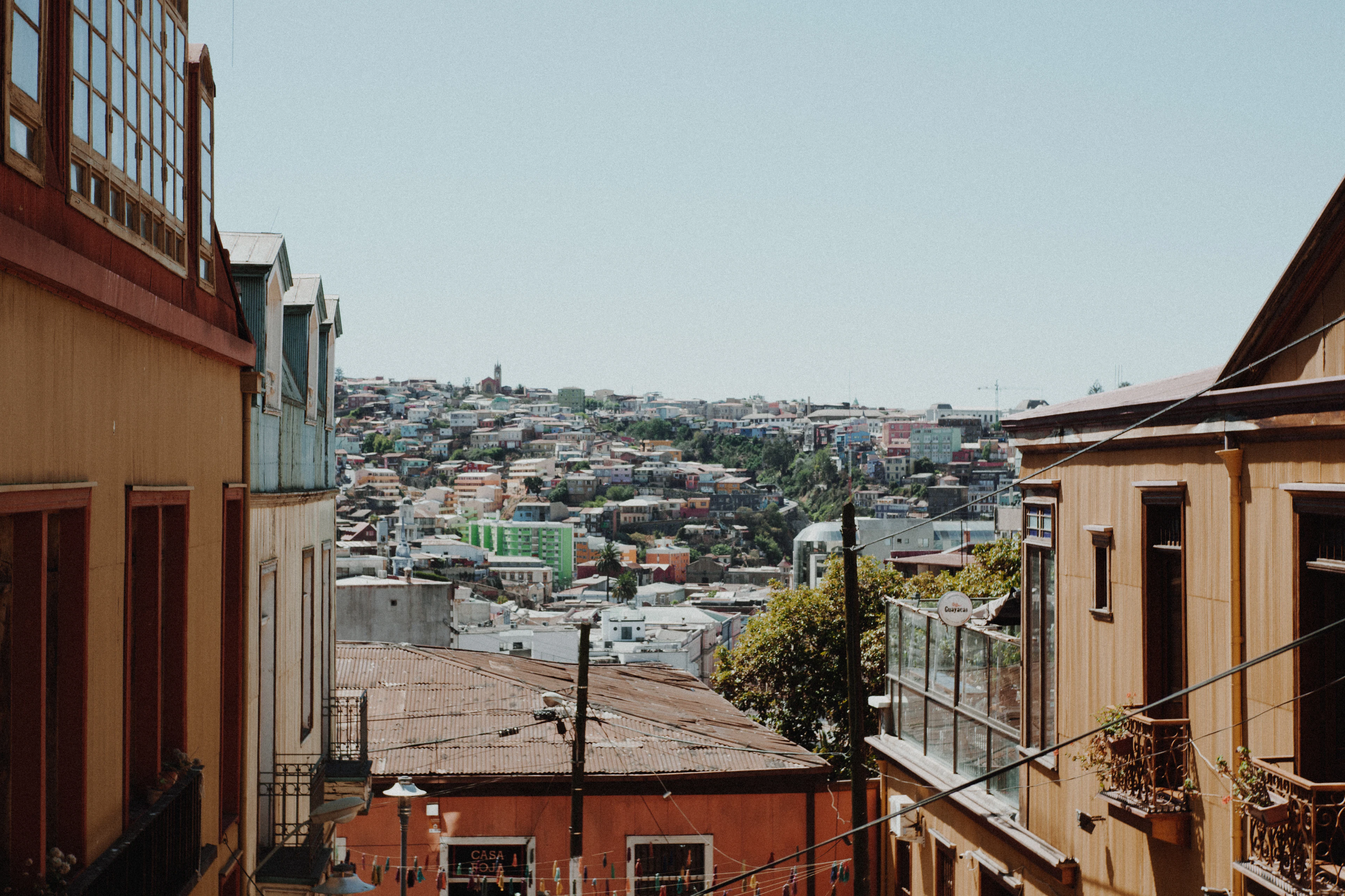 A view between old houses on Cerro Concepción across Valparaíso's hills, Chile