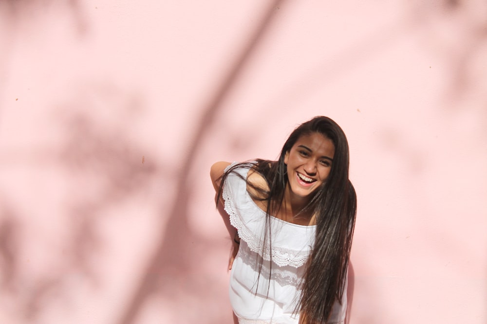 Photo de mise au point superficielle d’une femme en chemise blanche à épaules dénudées