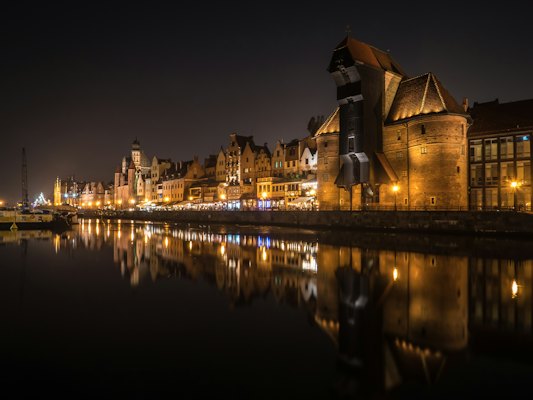 Castle with lights near body of water — Gdańsk, Poland