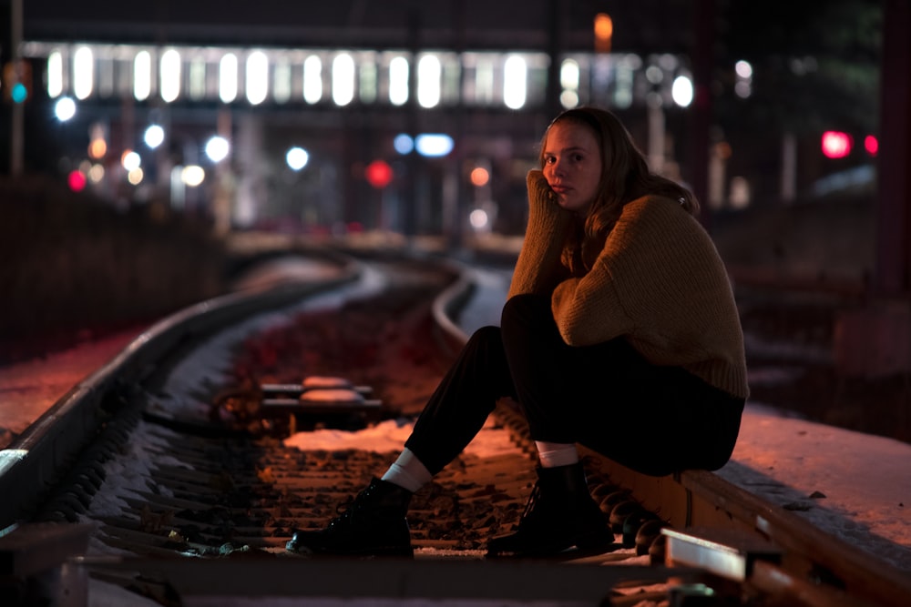 sitting woman resting head on right hand at night