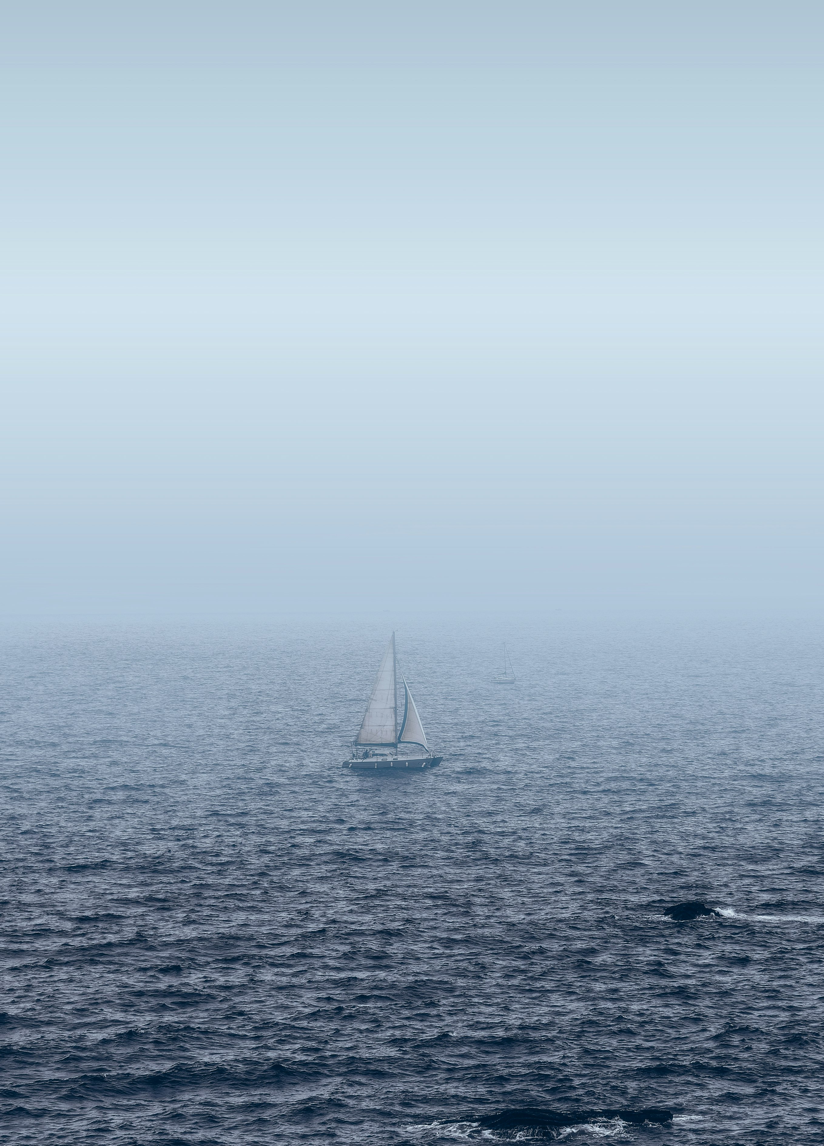 white sailboat on sea