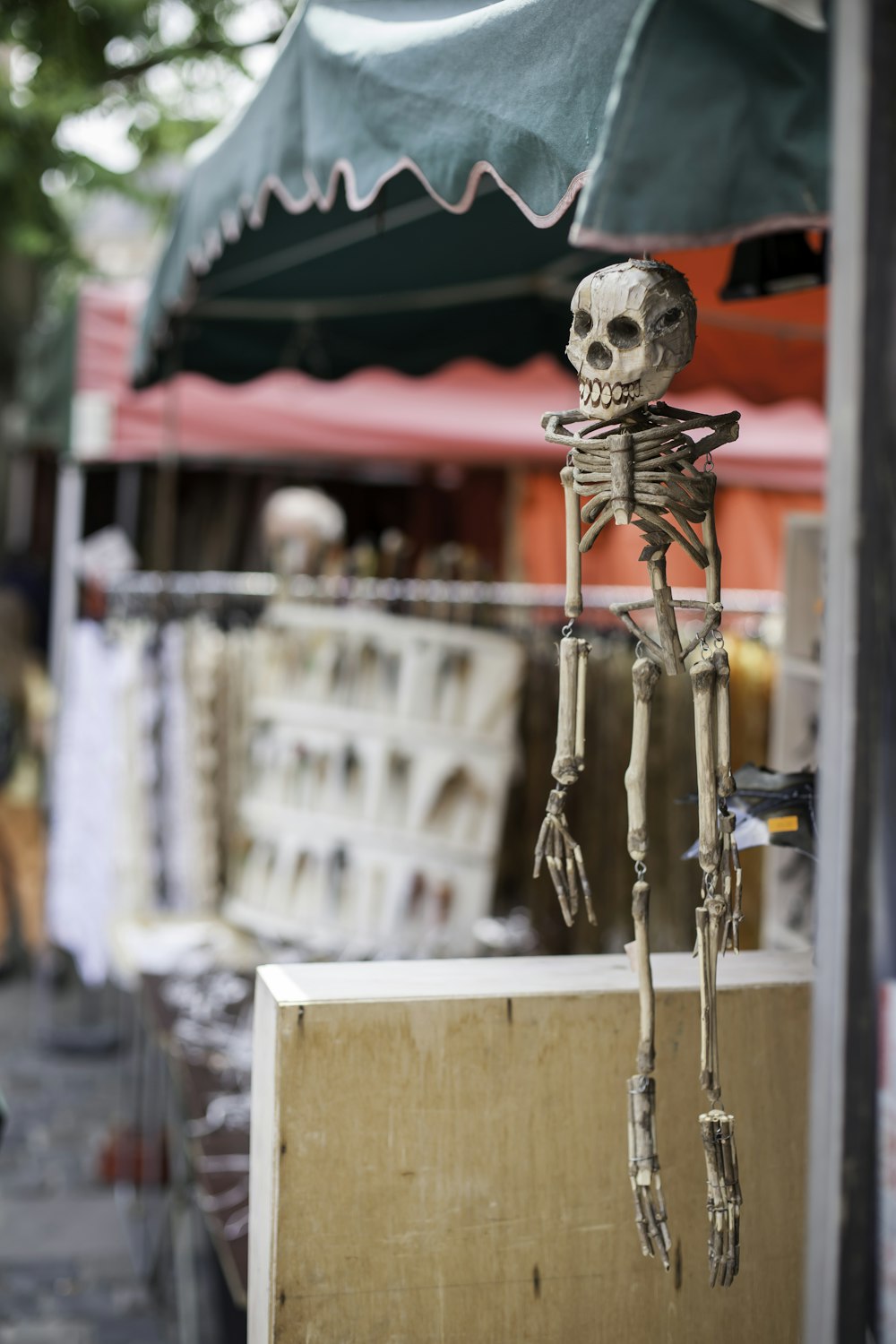 a skeleton hanging from the side of a building