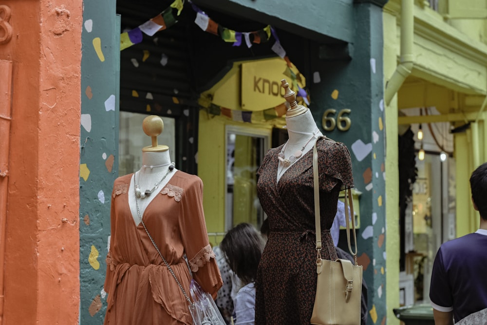 people standing near dress outdoor during daytime