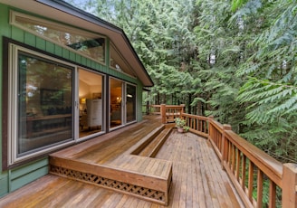 brown wooden terrace outside clear glass door