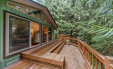 brown wooden terrace outside clear glass door