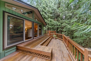 brown wooden terrace outside clear glass door