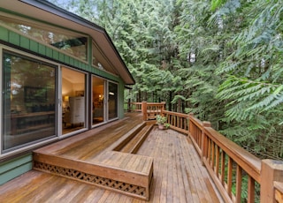 brown wooden terrace outside clear glass door