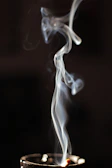 Soft-focus image of oud smoke curling upwards, evoking the rich aroma of Dar Oud fragrances.