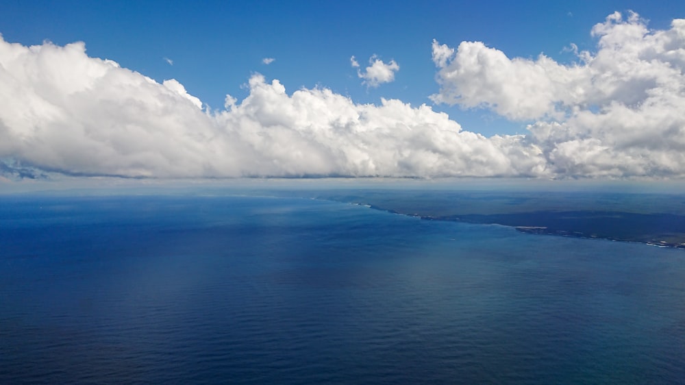 aerial photo of sea under cloudy sky