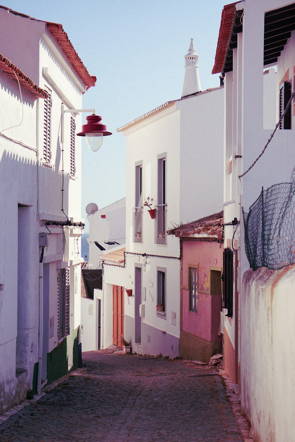 alley between white buildings during daytime