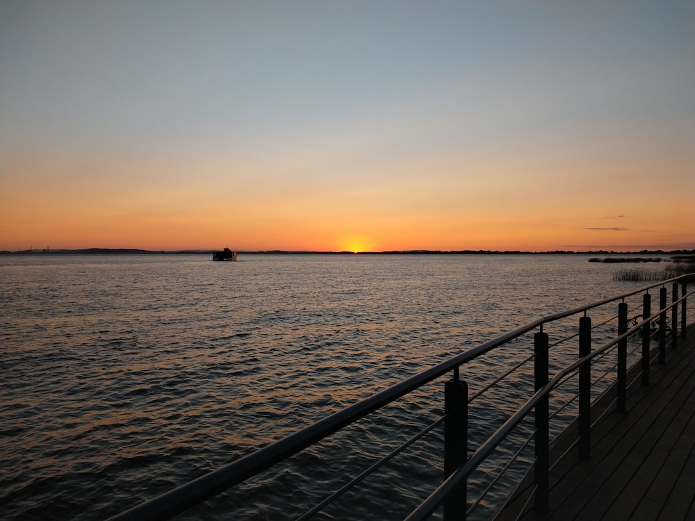 boat on body of water during sunset