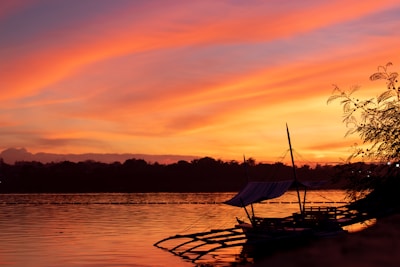 Sunset view over Lake Tanganyika with traditional fishing boats.