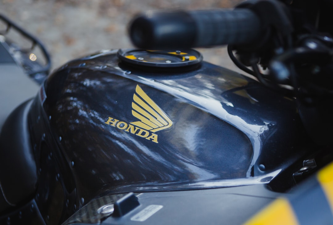 selective focus photography of black Honda motorcycle