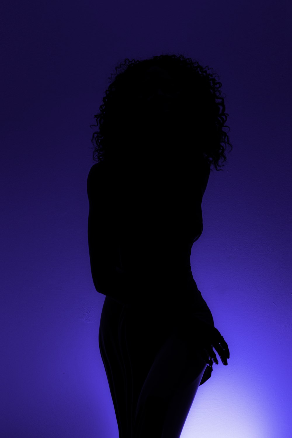 a silhouette of a person holding a cell phone