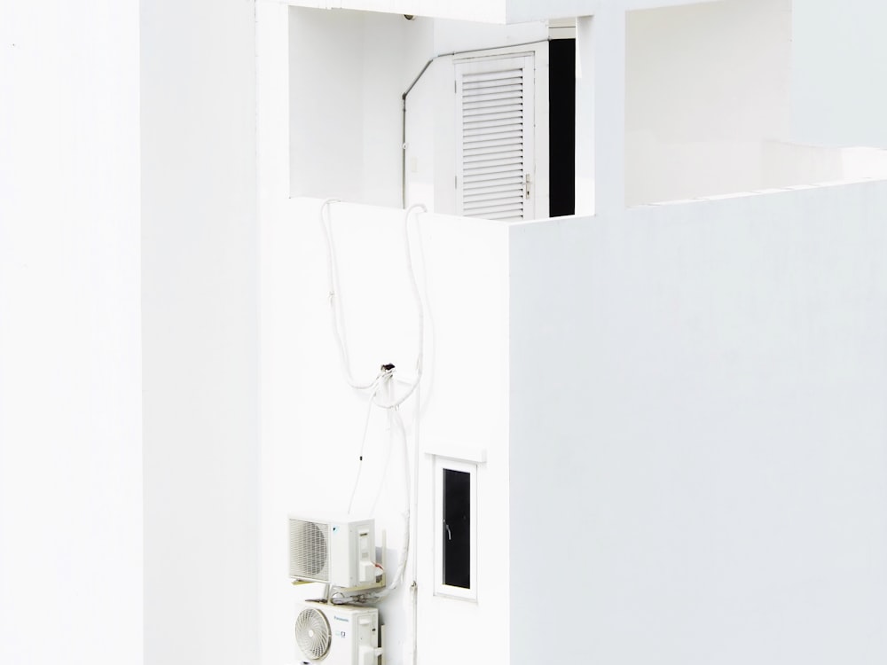 a white room with a wall mounted air conditioner