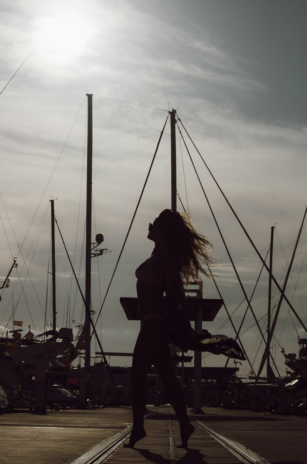 woman standing on road near boat during daytime