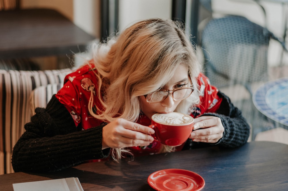 woman sipping latte in mug