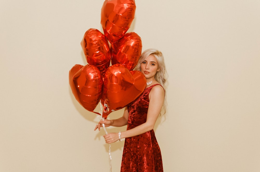 woman holding heart balloons