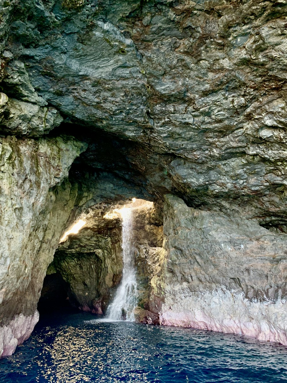 a cave with a waterfall coming out of it