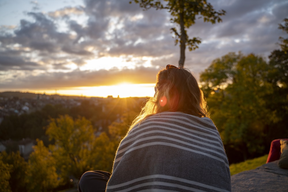 woman sitting on concrete ground