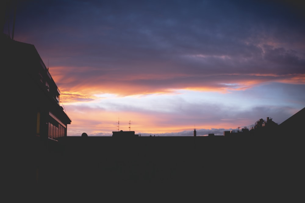 silhouette of houses during sunset