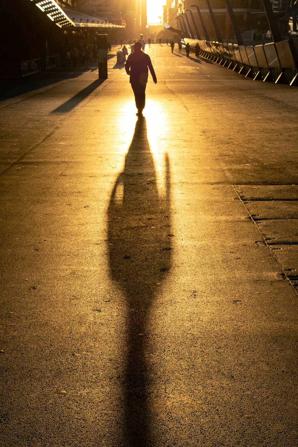 people walking on pathway near high-rise buildings during daytime