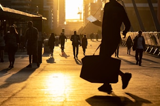 man walking on the field carrying bag