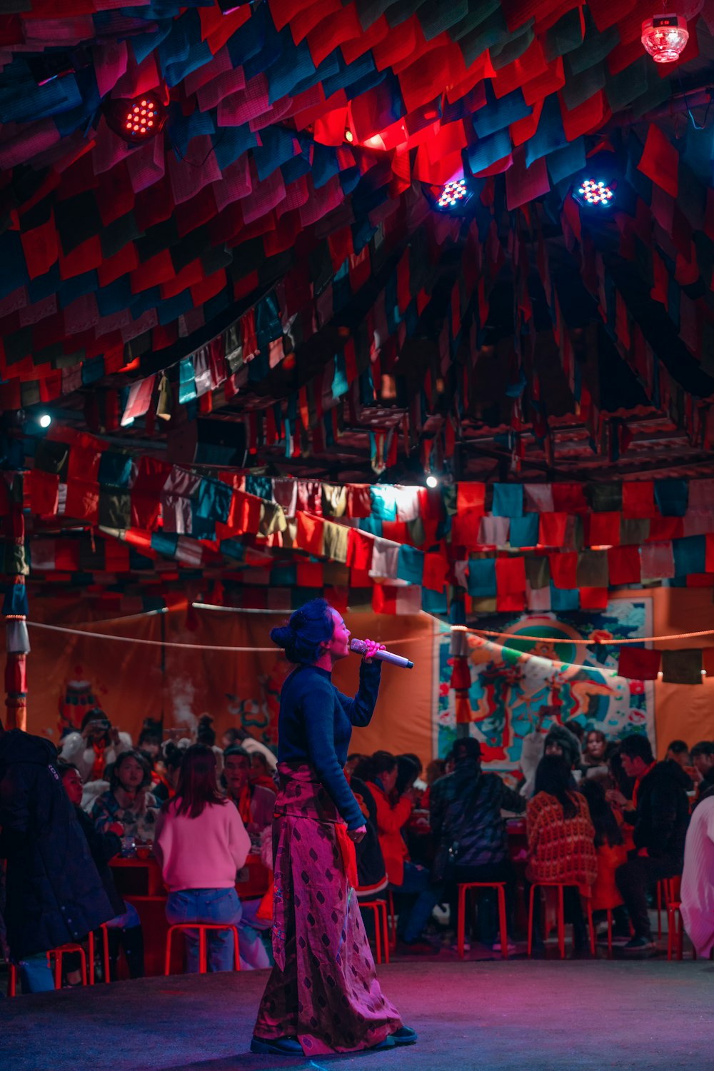 woman singing surrounded with people