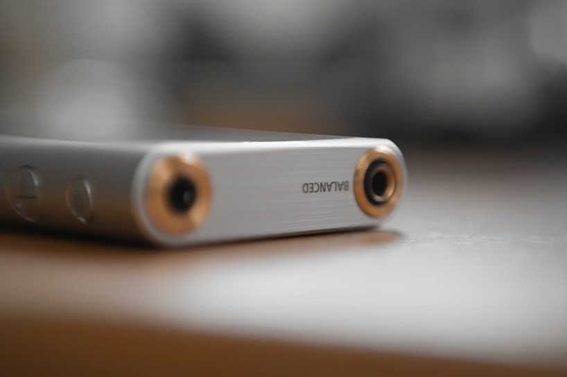 A sleek stainless steel audio component on a reflective surface.