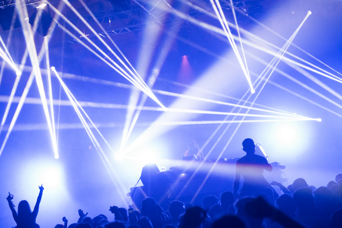 Crowd under coloured lights at a late-night event.