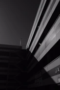 Black and white photo of a modern urban building with soft shadows and gradient lighting.
