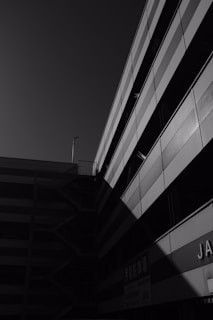 Monochrome photo of a modern building facade with geometric patterns.