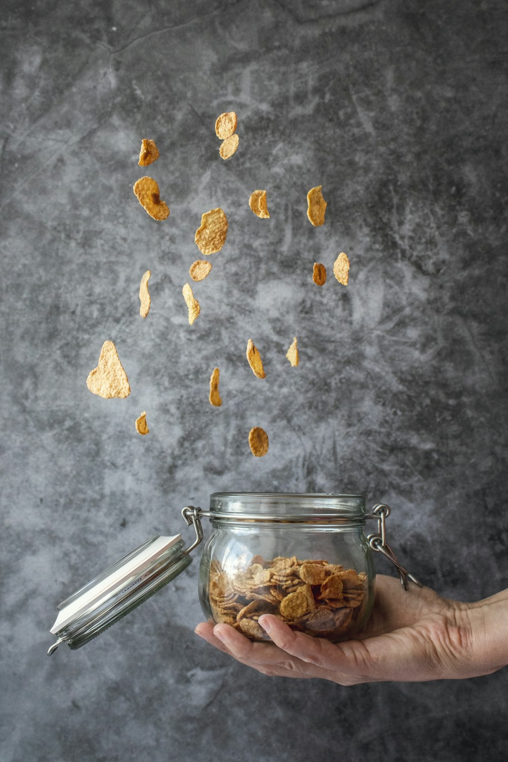 person holding jar of cereals