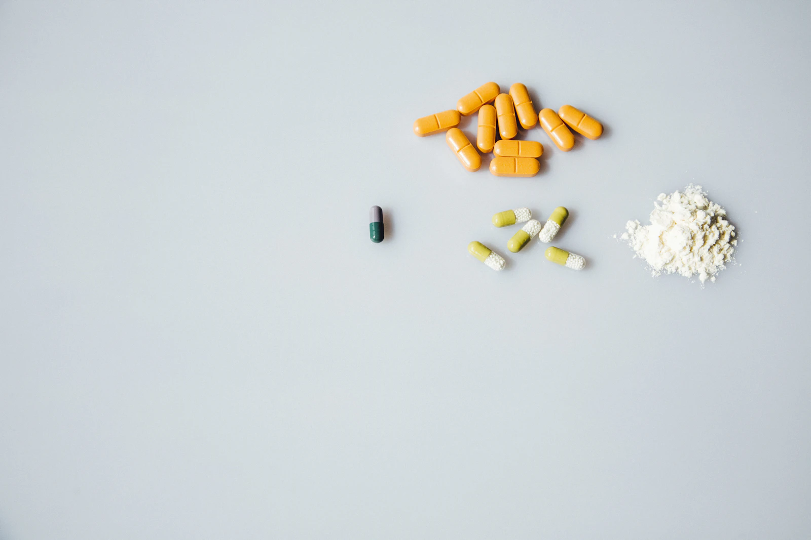 An assortment of oral medication capsules arranged on a surface.