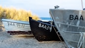 three gray, black, and white canoes