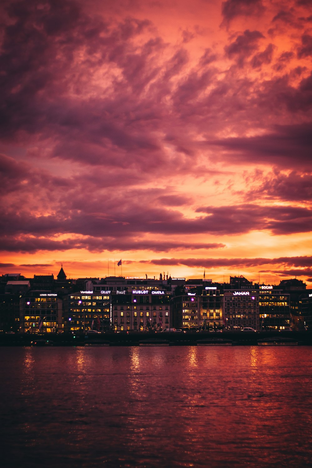 cityscape by water under golden hour