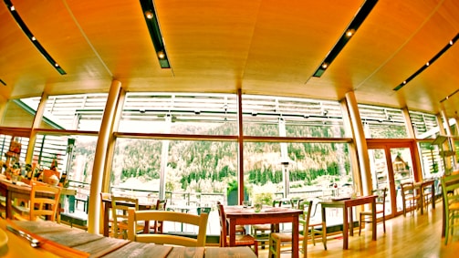 Cozy restaurant interior with transparent glass walls.