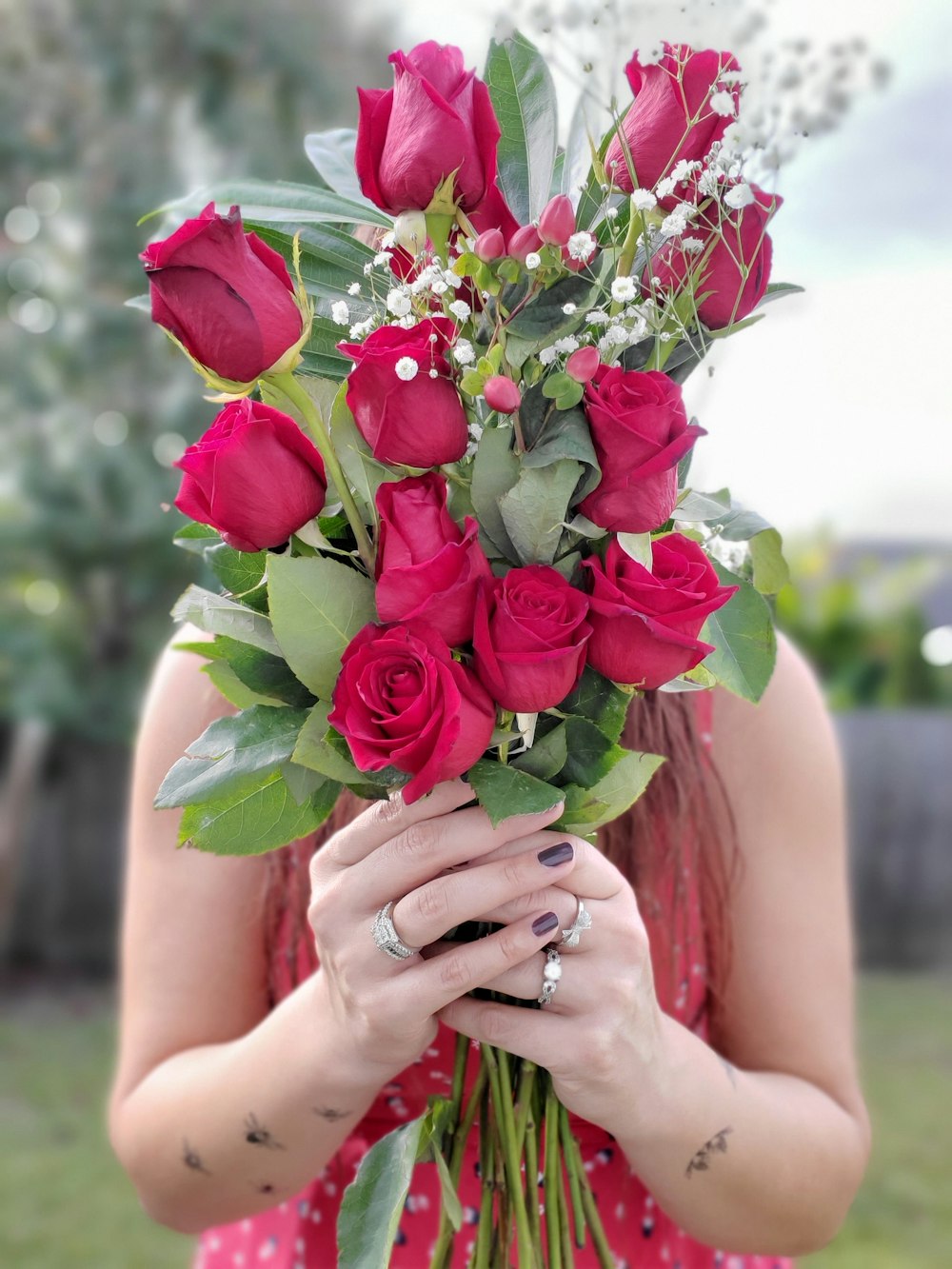 person holding bunch of rose