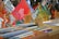 An assortment of vinyl records displayed in cardboard boxes at a market stall. The records are organized into categories with handwritten labels indicating various music genres such as soul, jazz, rock, and pop. Visible album covers feature vibrant artwork and typography, including artists like King Curtis.