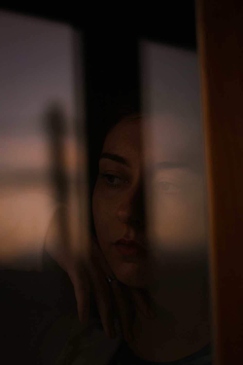 woman standing behind glass window
