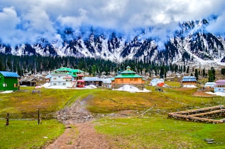 aerial photo of village beside mountain s