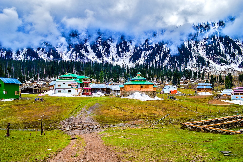 aerial photo of village beside mountain s