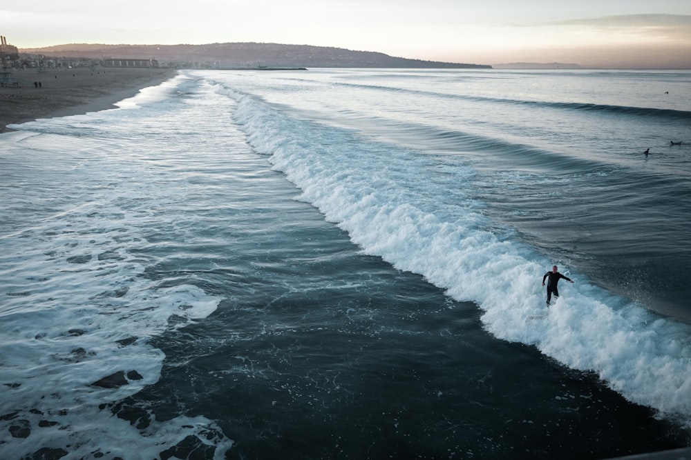 man surfing on sea