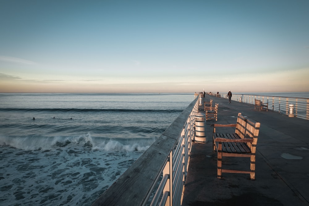 brown wooden chair on concrete bridge