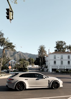 white 5-door hatchback on concrete pavement