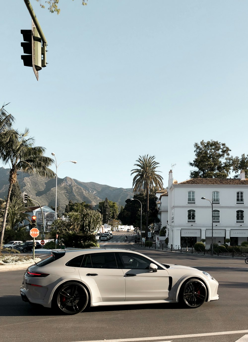 white 5-door hatchback on concrete pavement