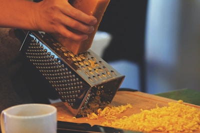 person grating cheese