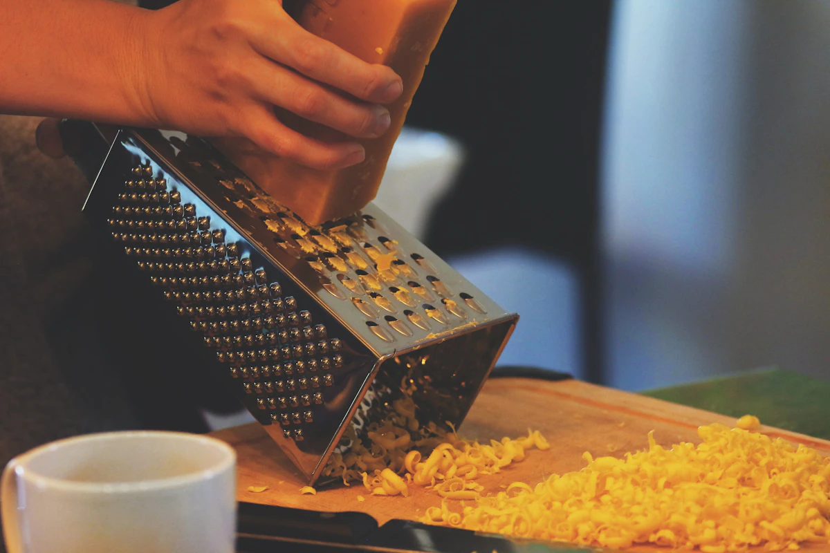 Person grating cheese - Chicken Quesadillas