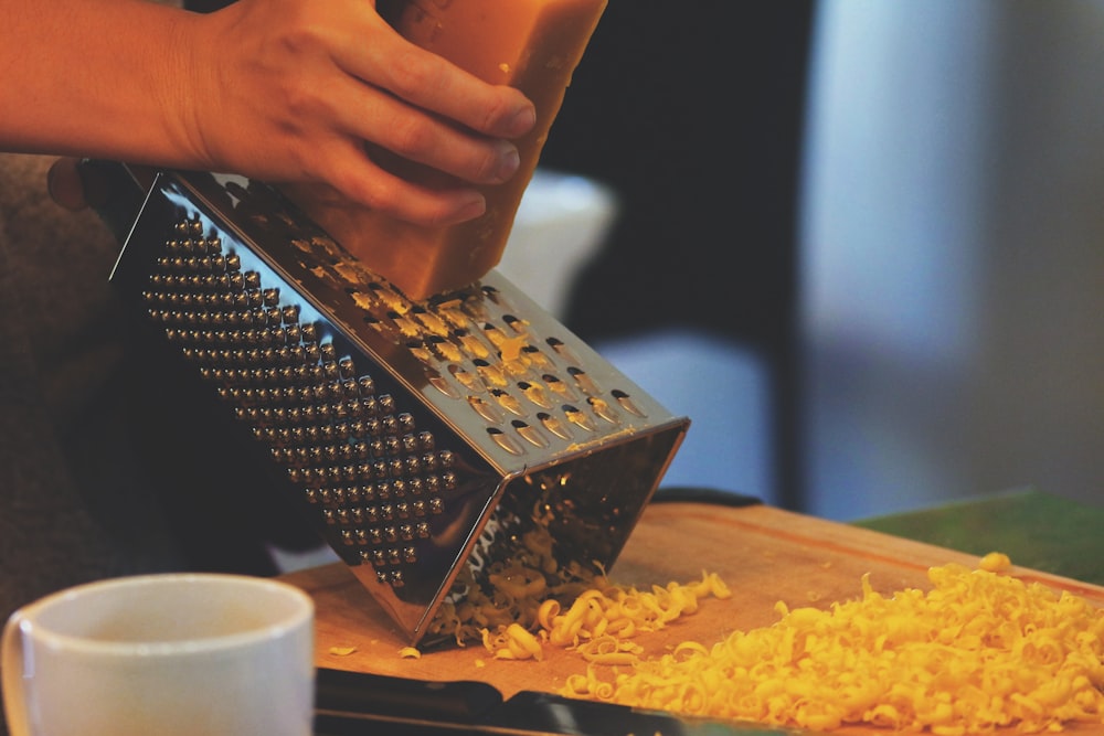 person grating cheese