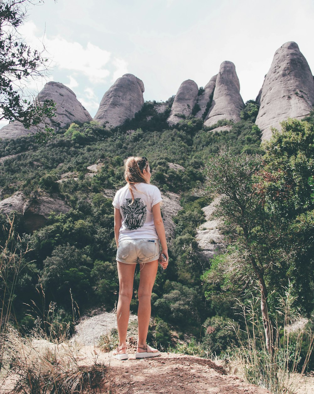 woman standing on rock formation